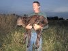 Brian carries the newborn calf to the barn.