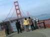 Asian tourists photograph the Golden Gate Bridge