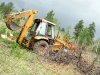 Hauling felled tree with 4WD Case 580K backhoe 