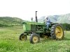 Larry Vickers mows hay on old John Deer tractor