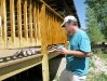 Jim painting the new deck behind Vickers Ranch rec hall
